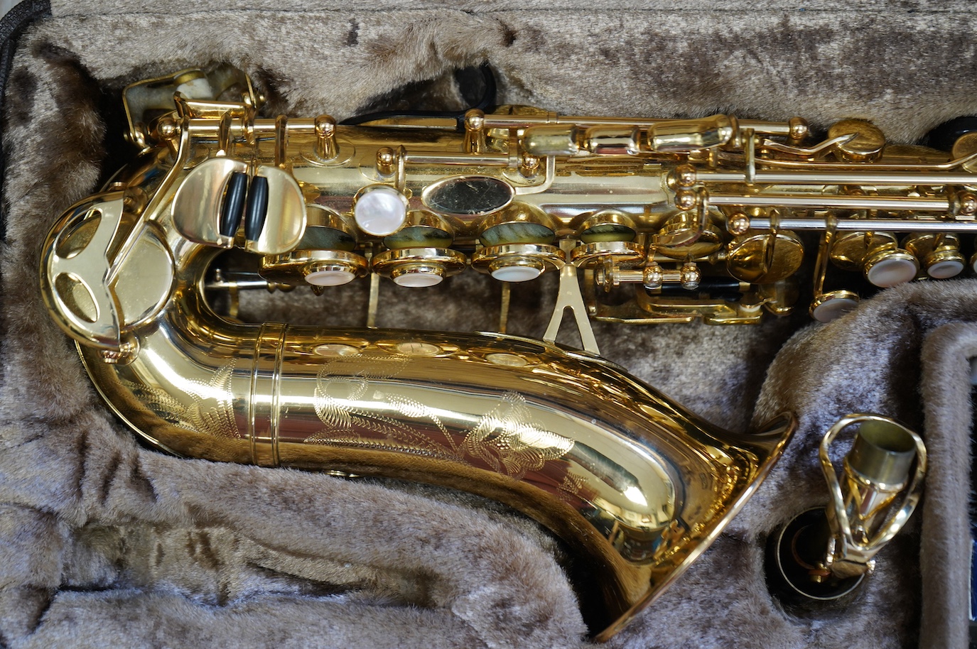 A cased Yanagisawa brass soprano saxophone with engraved decoration. Condition - good